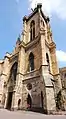 Façade and steeple. Note the unusual, massive supporting pillars