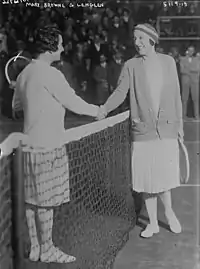 Lenglen and Browne smiling and shaking hands at the net