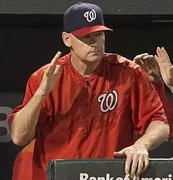 Matt Williams slaps the dugout railing with the Washington Nationals.