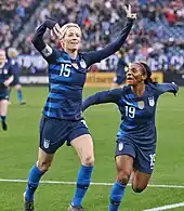 Rapinoe celebrates a goal with teammate Crystal Dunn, 2019