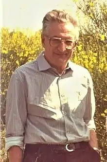 A middle-aged man stood in scrubland