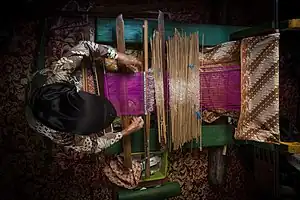 Image 60A traditional tailor (Tenun) from Sumatra, in the process of sewing (from Culture of Indonesia)