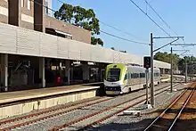 Passenger train at long platform with full length shelter