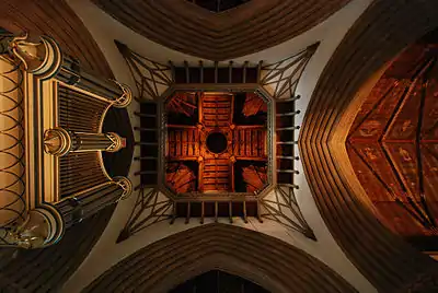 The interior of the chapel from under the tower, looking towards the roof, with the former organ on the left