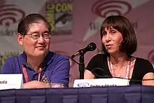 Okuda speaking at the 2013 WonderCon alongside her husband Michael