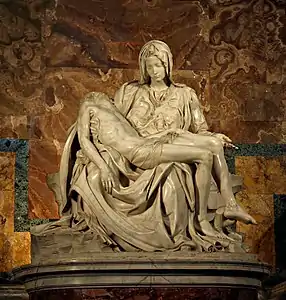 image of Michelangelo's famous sculpture the Pieta. Mary is seated looking at the body of her son draped across her lap.