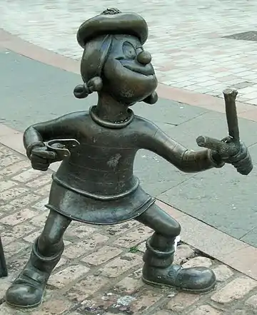 Image 60Statue of Minnie the Minx, a character from The Beano, in Dundee, Scotland. Launched in 1938, The Beano is known for its anarchic humour, with Dennis the Menace appearing on the cover. (from Culture of the United Kingdom)