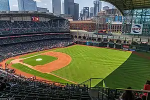 View of a baseball stadium, taken from the upper deck and looking out over the field from right field. Open roof