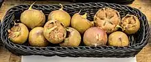 basket full of small, brown, round fruits