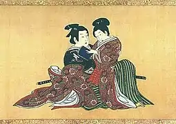 A kagema sits upon his elder patron's lap. Miyagawa Isshō, Spring Pastimes, 1750