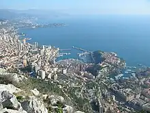 Image 6In the centre is La Condamine. At the right with the smaller harbour is Fontvieille, with The Rock (the old town, fortress, and Palace) jutting out between the two harbours. At the left are the high-rise buildings of La Rousse/Saint Roman. (from Monaco)