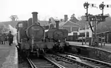 Monmouth Troy in November 1958. On the left is 0-4-2T No. 1455 pushing an auto-train from Ross-on-Wye. On the right is  0-6-0PT No. 6439 on a train to Severn Tunnel Junction