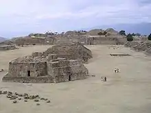  some ancient stone ruins of buildings in a sandy area