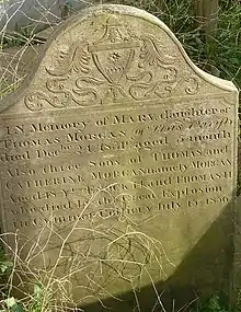 An engraved sandstone gravestone.