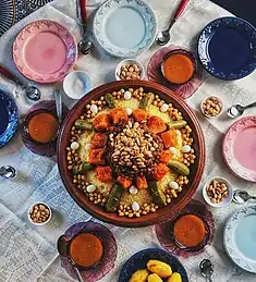 Image 12Couscous is traditionally enjoyed on Friday, the holy day in Islam. Garnished with vegetables and chickpeas, it is served communally. (from Culture of Morocco)