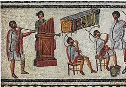 Image 35Musicians playing a Roman tuba, a water organ (hydraulis), and a pair of cornua, detail from the Zliten mosaic, 2nd century AD (from Culture of ancient Rome)