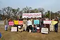 Group of people holding signs and banners