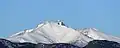 A view of the snow-covered Mount Meeker from Longmont. The rugged summit of Longs Peak is peeking out from behind.