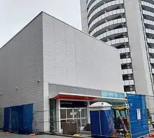 Photo of a largely completed sleek, modern light rail station entrance.