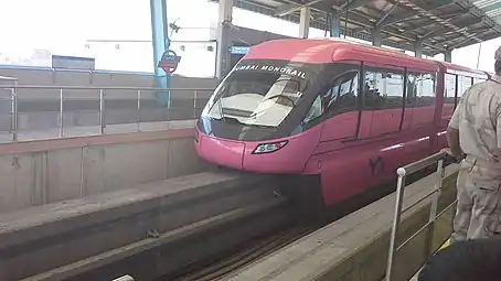 Pink monorail at a station