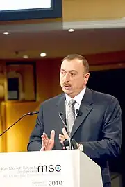 Ilham Aliyev speaking at a podium