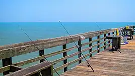 Myrtle Beach State Park's pier with fishing poles cast off the side