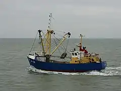 Fishing vessel equipped with a benthic dredge, leaving the port of Nieuwpoort