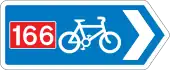 Rectangular, blue traffic sign with a white bicycle symbol and a red square with the number 166 in it.