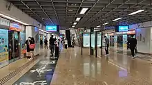 Underground platforms of the NEL, with calligraphic writing on the floor at the left