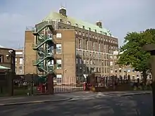 Older, multi-story building with an external fire escape