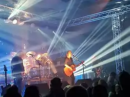 New Model Army performing in 2022, left to right: Dean White (keyboards and guitar), Michael Dean (drums), Justin Sullivan (vocals and guitar), Ceri Monger (bass).