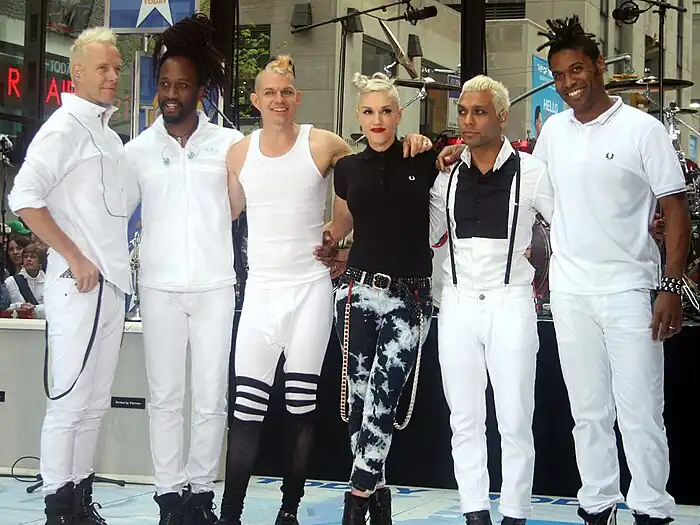 A color photograph of No Doubt bowing together after a concert in May 2009.