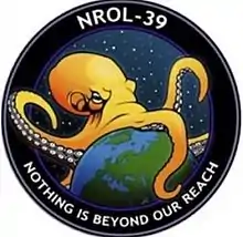 A mission badge of an octopus spanning the world against a starry background, labelled "NROL-39" and "Nothing is beyond our reach"