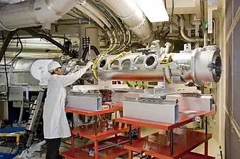 A technician loads an instrument canister into the vacuum-sealed diagnostic instrument manipulator.