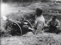 NRA troops firing artillery at Communist forces