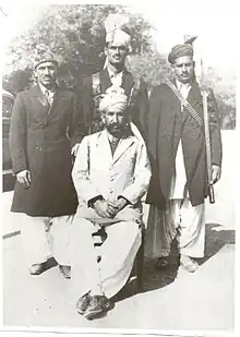 Standing, left to right: Doctor Masdar Ali (Physician of the Nawab of Amb), some servants of the Nawab of Amb) Sitting: Nawabzada Mohammad Ismail Khan Tanoli of Chanser and brother of Nawab Khan i Zaman Khan Tanoli