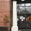 Standing at the entrance of the current temple, a single column from the original temple, the only surviving remnant from the fire in 1982.