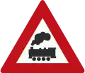 J11: Level crossing without barrier or gates ahead (formerly used )