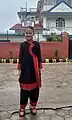 A girl is preparing to go to school in a Newari dress Tapaln