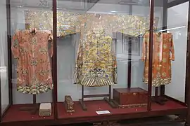 Nguyen dynasty court dress: left and right only have woshui; middle have both woshui and lishui patterns.