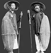 Picture depicts two Nguyễn dynasty soldiers with rattan shields and two-handed Vietnamese sabres.