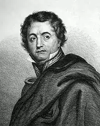 Black and white print shows a wavy-haired man looking to his left. He wears a cloak over his shoulders so that only the collar and one epaulette of his military uniform are visible.