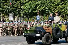 President of the Republic Nicolas Sarkozy and General Jean-Louis Georgelin, Chief of the Defence Staff, reviewing troops during the 2008 Bastille Day military parade on the Champs-Élysées in Paris.