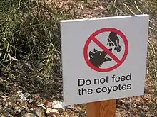 This sign discourages feeding coyotes, which can result in aggressive behavior toward humans