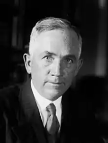 A black and white photo of an elderly white man looking directly at the camera.