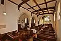 Inside the nave of Holy Trinity parish church, looking east to the chancel (right) and north arcade (centre)