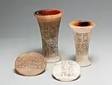 Two vases and lids covered with hieroglyphic inscriptions