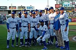 Men in baseball uniforms standing on a baseball field