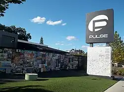 Photo of a white low-rise building and parking lot.