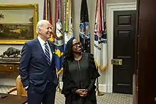 Photo of Biden and Jackson looking at an off-camera television screen